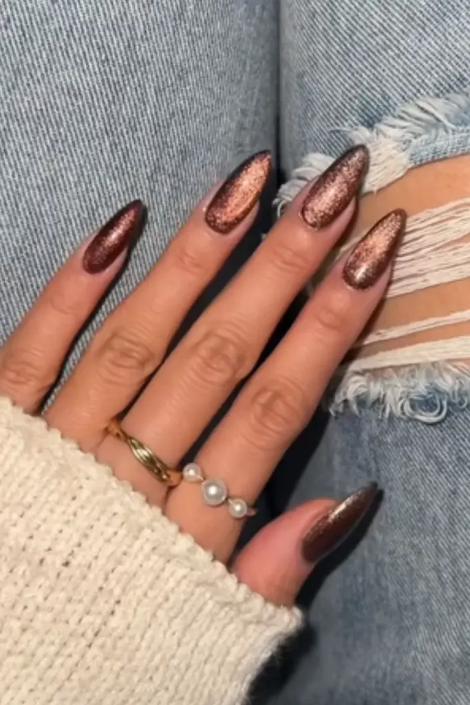 metallic shimmery bronze nail set on long almond nails