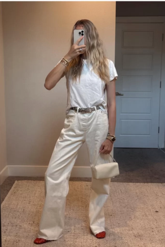 woman wearing off-white jeans and tee outfit as a late summer outfit