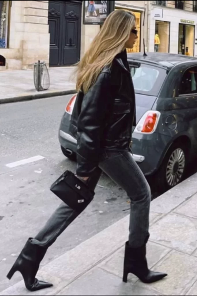 Influencer wearing dark skinny jeans with black leather boots over as a chic Fall 2025 outfit