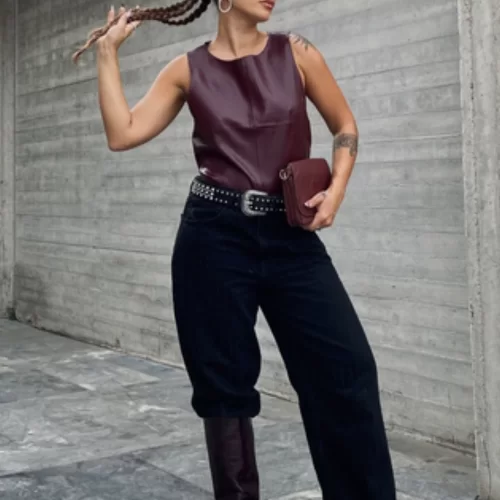 Knee-high boots worn under and over baggy jeans, demonstrating 2025’s top trend for fall and winter denim looks