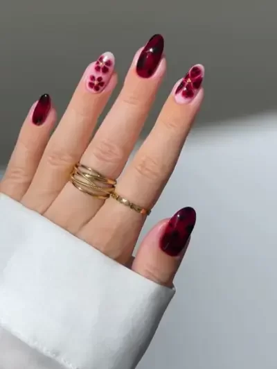 Fall floral nail art done with deep burgundy tones