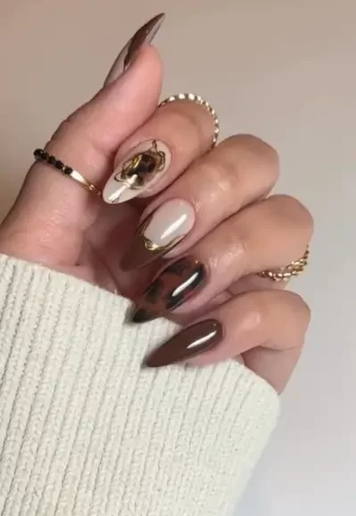 Tortoise inspired nail art with maximalist accents on different nails