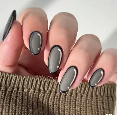 cartoon nail art design with a grey base and black outline