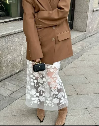 sheer maxi skirt with floral appliqué styled with suede boots and a tan oversized blazer