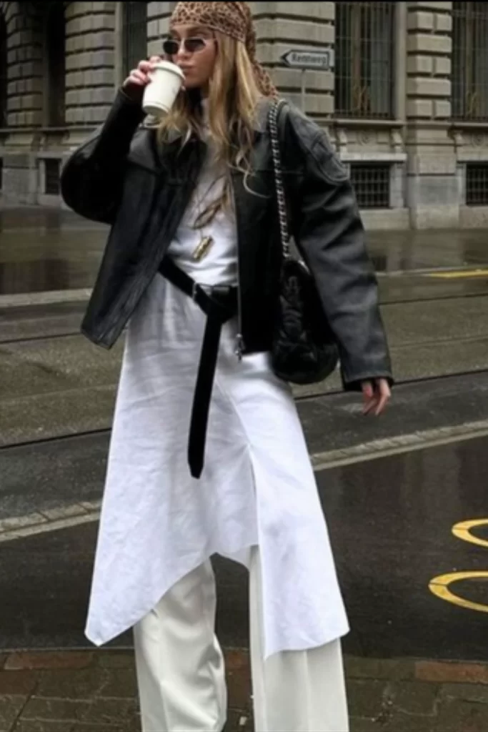 boho layered outfit inspiration with white wide leg pants and flowy top with jacket over