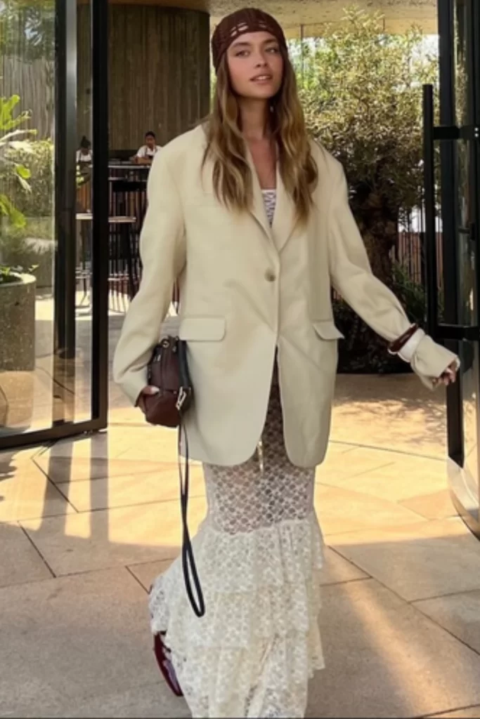 woman wearing modern boho dress styled with a knit beanie and oversized blazer for Fall