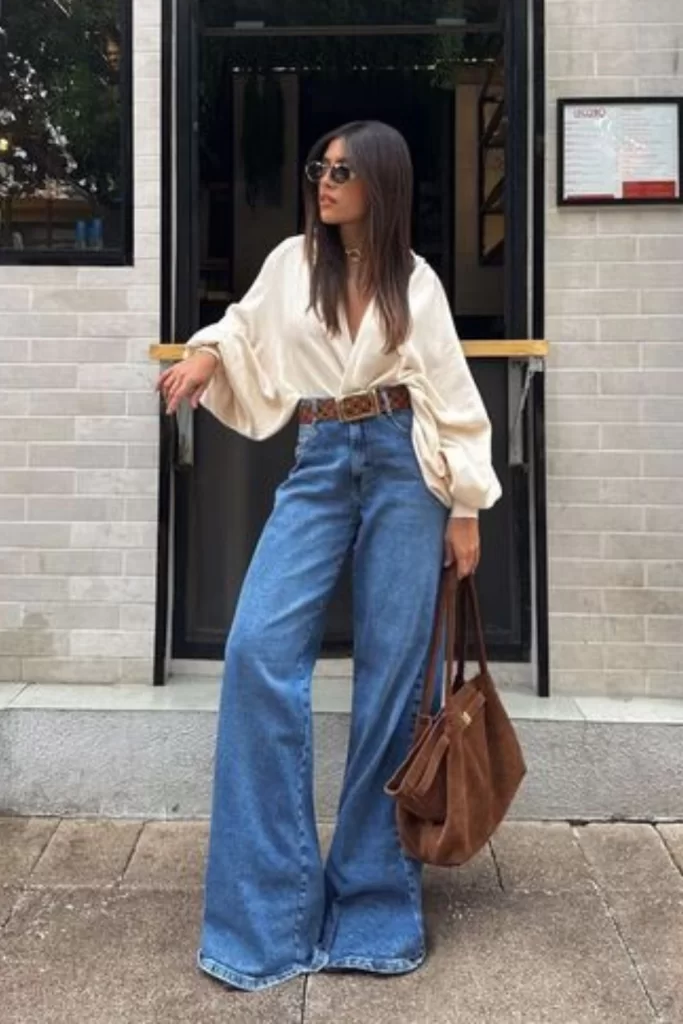 woman wearing casual boho chic outfit with wide jeans and balloon sleeve top