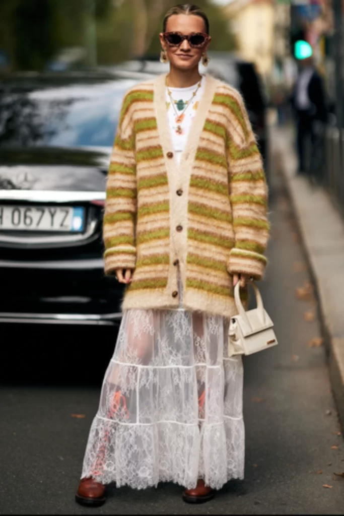 boho chic fall outfit inspiration with an oversized striped cardigan in earth tones paired with maxi lace sheer skirt and boots