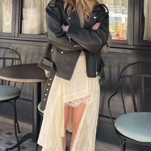 moto boho outfit on young woman wearing flowy lace dress and leather jacket