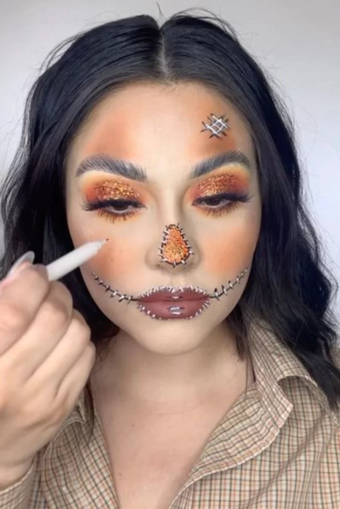 Cute and glittery scarecrow makeup inspiration on young brunette woman for Halloween