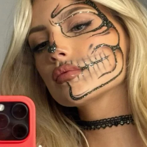 Simple glittery skeleton Halloween makeup on young blonde woman with glitter accents along the black outline