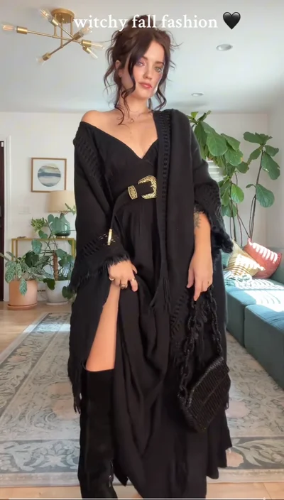 Witchy Fall inspired outfit on young woman wearing flowy black dress and belt