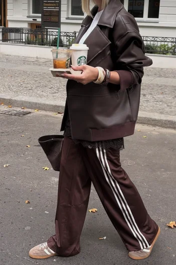 Dark Fall outfit inspiration with silky track pants and a dark leather bomber