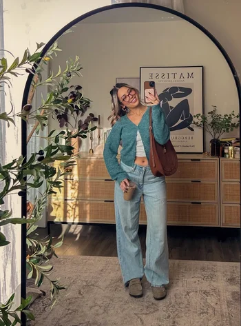 Cute and comfortable fall outfit with relaxed jeans, colorful sweater and clogs