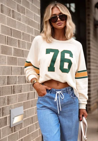 Model wearing sports jersey inspired top and jeans