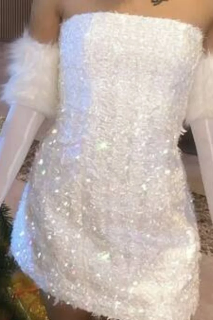 Cropped photo of woman wearing white embellished mini dress and sheer elbow length gloves with fur trim