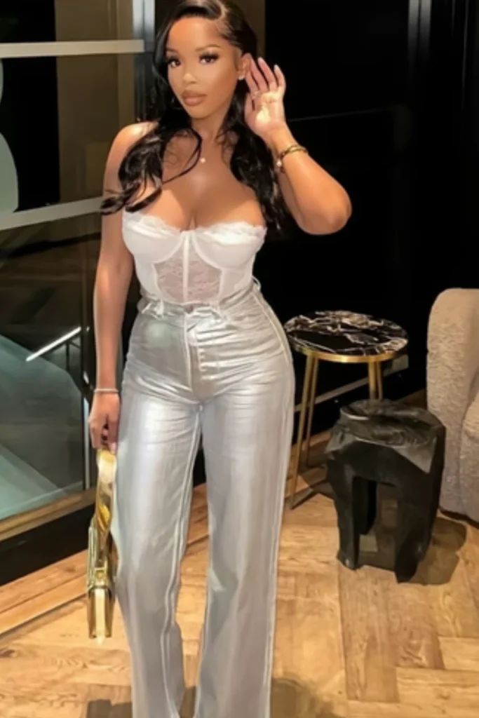 Woman wearing silver jeans and white lace bodysuit