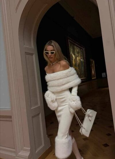 Model wearing white fur trim midi sweater dress